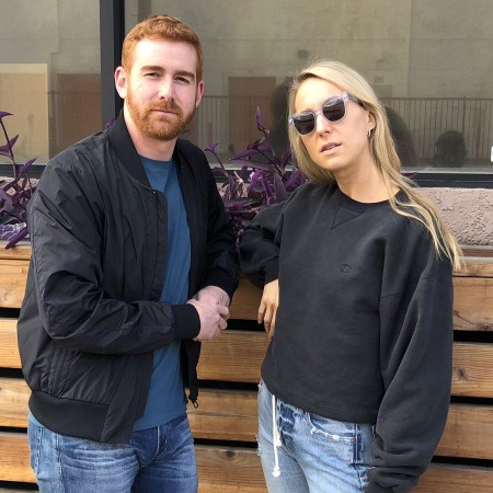 Andrew Santino and her wife standing on a street with black look