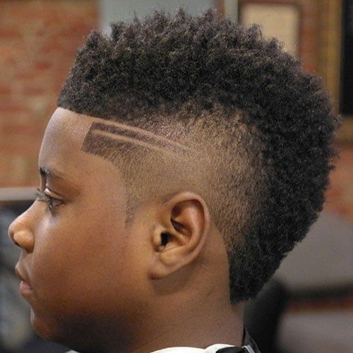 A west indies little boy having Burst-Fade Mohawk haircut 