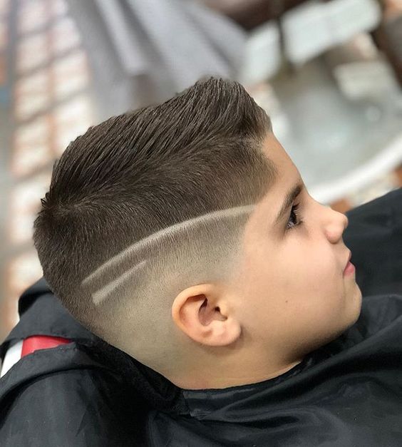 A little boy just had High Skin Fade with Shaved Designs