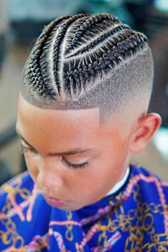 a black boy having Low Skin Fade with Twists haircut in a barber shop