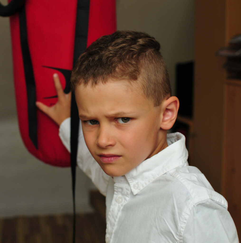 little boy standing in gym room with Side Brushed Top Undercut hairstyle